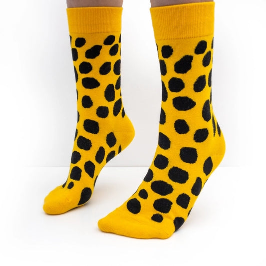 Bold yellow crew socks with playful black polka dots by Sarah Corynen – size 38-42, unisex, cotton blend, fun illustrated design for colorful everyday wear.