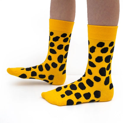 Bold yellow crew socks with playful black polka dots by Sarah Corynen – size 38-42, unisex, cotton blend, fun illustrated design for colorful everyday wear.