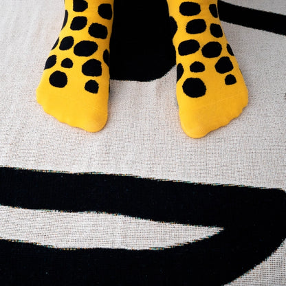 Bold yellow crew socks with playful black polka dots by Sarah Corynen – size 38-42, unisex, cotton blend, fun illustrated design for colorful everyday wear.