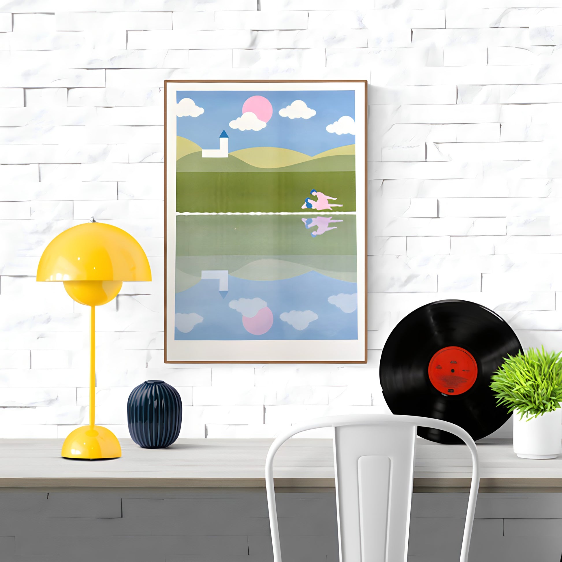 Risograph art print titled A peaceful town by Studio Stoutpoep, featuring a surreal countryside scene with rolling hills, a white church, and two nude figures in an intimate moment near a reflective lake. A2 size print in soft pastel colors, printed in Belgium with soy-based inks.