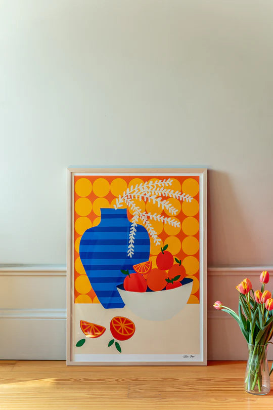 Colorful graphic illustration of a blue-striped vase with leaves and a bowl of oranges on a retro kitchen table, set against a bold orange patterned wall – Oranges on Retro Kitchen by Teresa Rego, A3 art print.