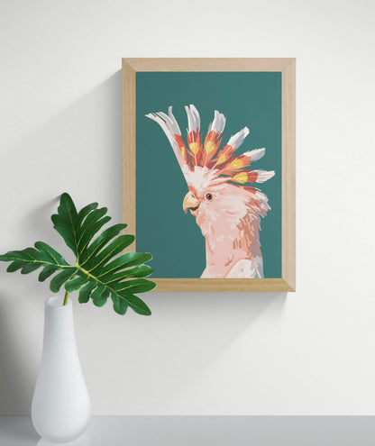 “Fashionista” by Floor 4 Productions – Digital art print of a pink cockatoo with vibrant yellow and orange crest on a muted green background, minimalist A4 wall decor made in Belgium.