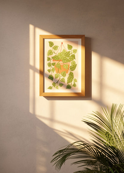 Scindapsus plant art print by Leens with cascading green leaves in a hanging terracotta pot on a blush pink background, modern botanical wall decor for cozy interiors.
