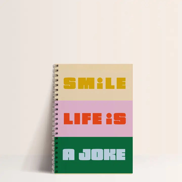 Colorful A5 spiral notebook with bold text "Smile, Life is a Joke" on recycled paper cover, featuring 60 blank pages of 80gsm paper, made in France – perfect for artists, students, and stationery lovers with attitude