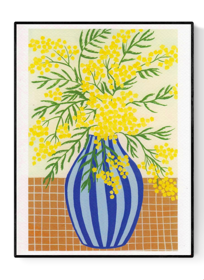 Botanical digital art print titled “Mimosa” by Belgian illustrator Leens, featuring vibrant yellow mimosa flowers in a blue striped vase on a tiled table, printed on textured fine art paper in A4 size.