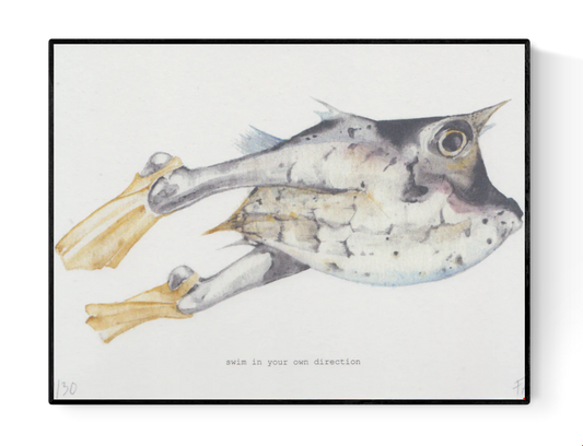 Surreal A5 art print titled Swim in your own direction by Belgian illustrator FAB. Features a watercolor fish with human legs and yellow fins, paired with the quote "Swim in your own direction". Printed on 300g Munker Pure rough paper, ideal for unique and inspirational home decor.