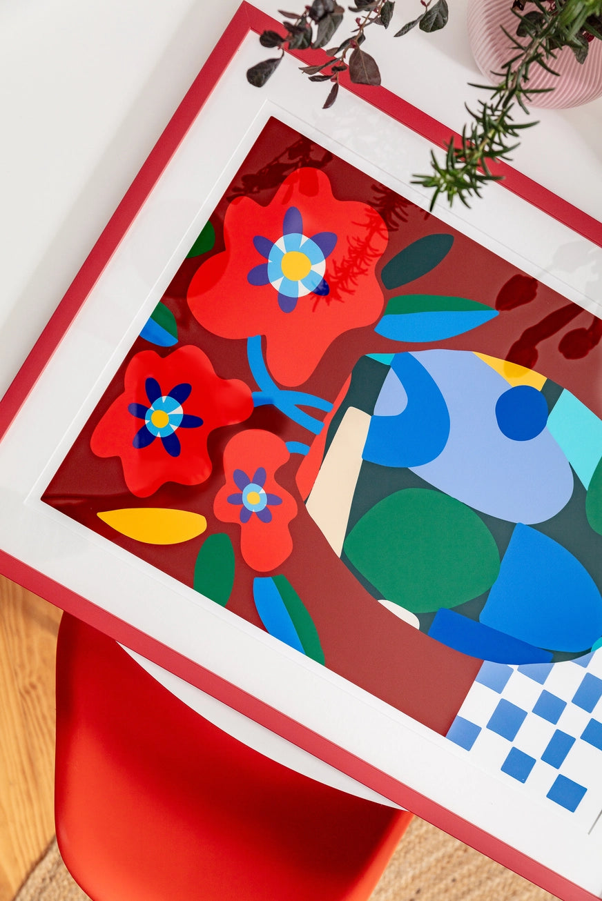 Burgundy on Check by Teresa Rego – colorful abstract floral art print with red flowers in a geometric vase on a checkered tablecloth, bold contemporary design perfect for modern home decor, available at Galerie Frits