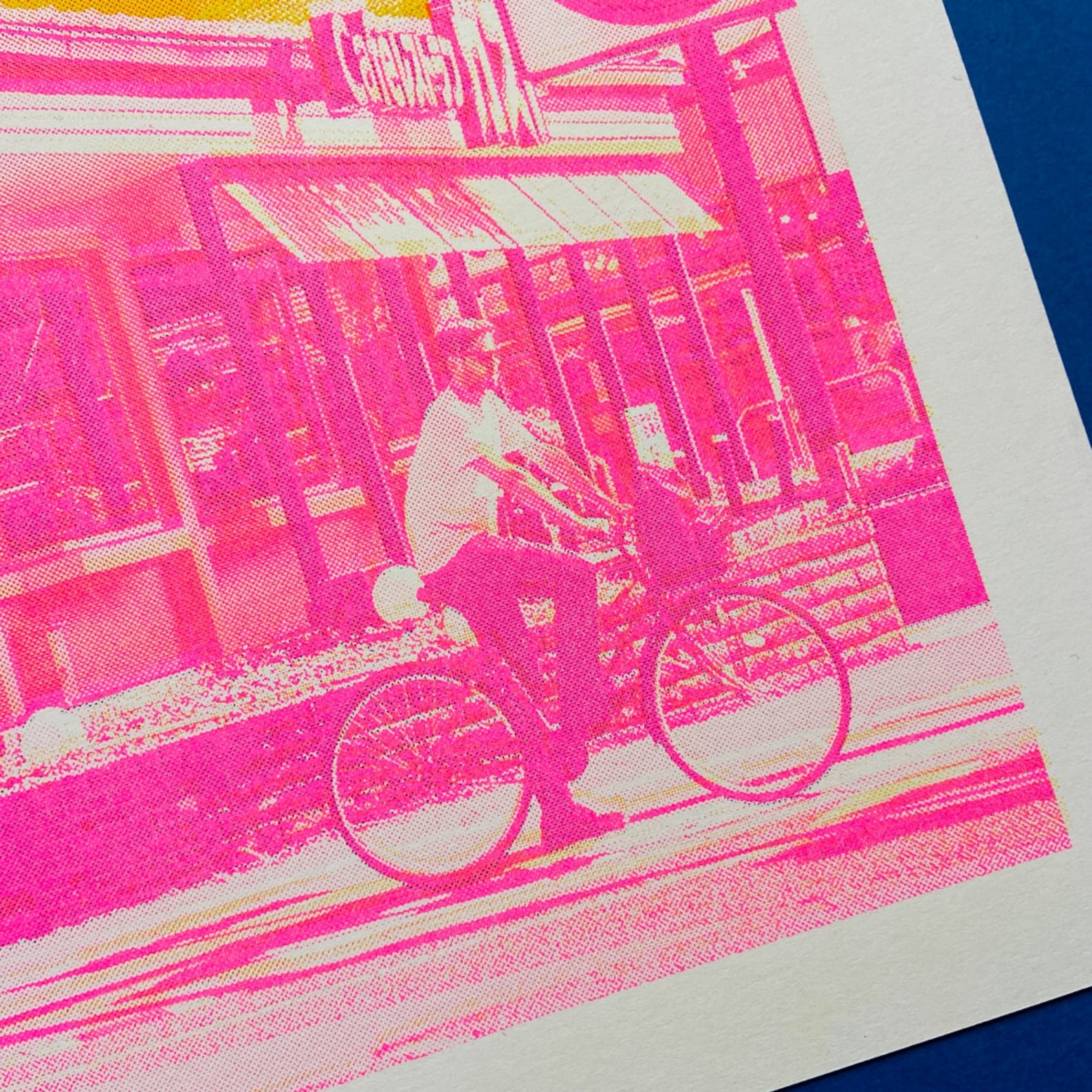 Bold Japan-inspired art print with pink urban street scene, cyclist, yellow Fuji pagoda silhouette and deep blue mountain background – Fuji Landscape Collage 2 by Dutch artist PTRVRKD, A3 risograph print, limited edition.