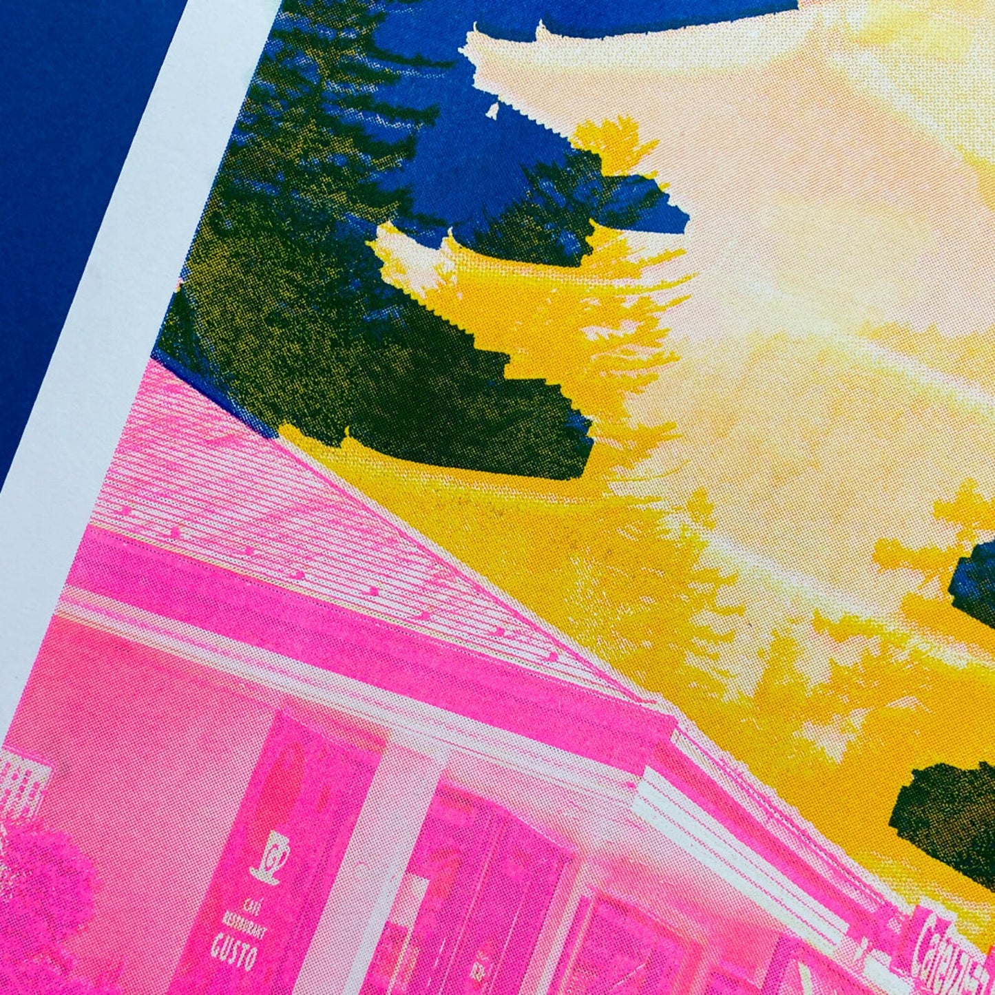 Bold Japan-inspired art print with pink urban street scene, cyclist, yellow Fuji pagoda silhouette and deep blue mountain background – Fuji Landscape Collage 2 by Dutch artist PTRVRKD, A3 risograph print, limited edition.