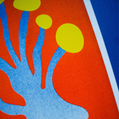 Blue and yellow funky mushroom risograph print by Dutch illustrator PTRVRKD – playful abstract botanical design with organic blue stems, bold yellow caps, and fiery orange background, printed with eco-friendly soy inks on 250 gsm Biotop paper, handmade in the Netherlands – quirky small art print for modern interiors.
