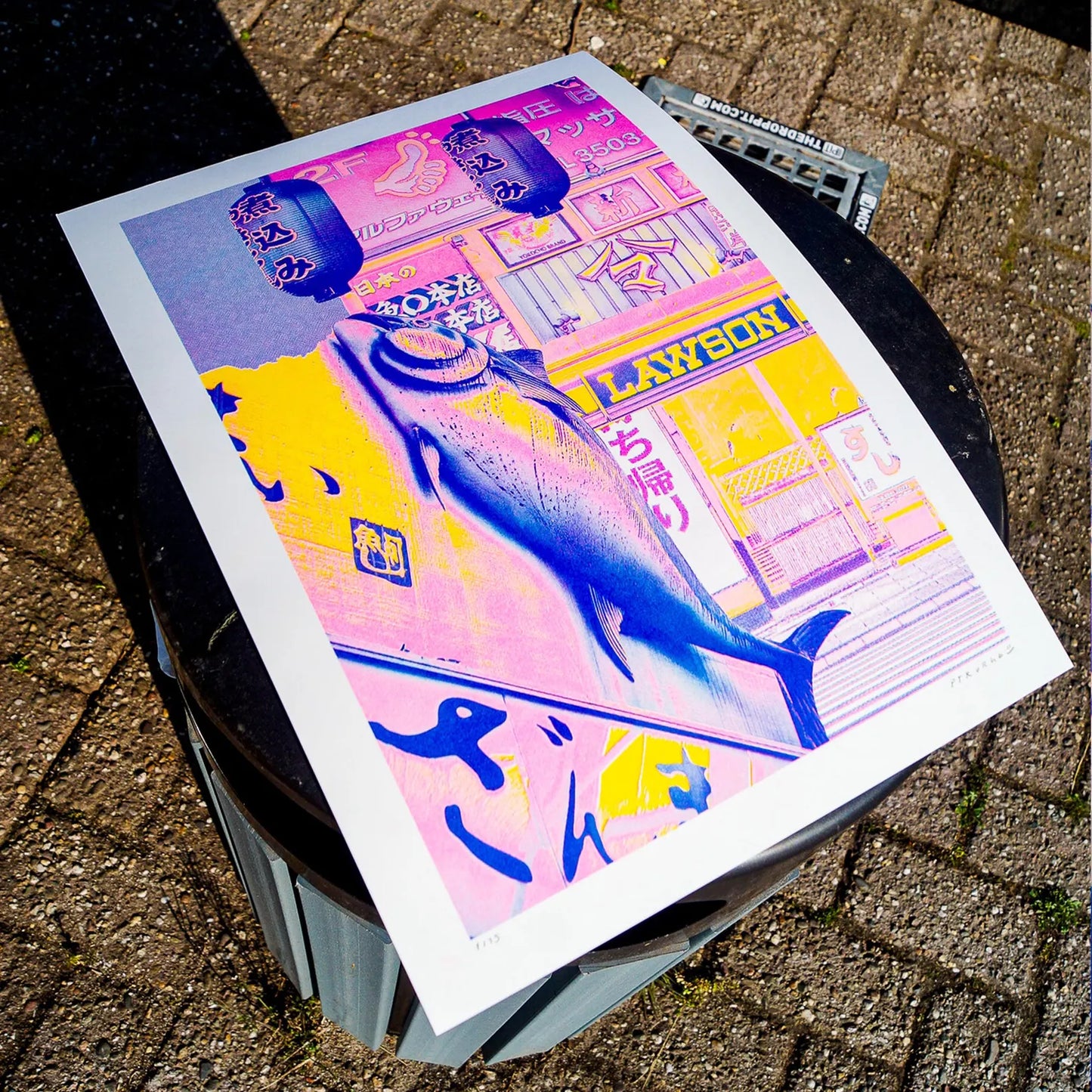 A3 risograph collage print of a surreal Tokyo street scene with fish and lanterns by PTRVRKD, handmade in bold pink, blue, and yellow tones.