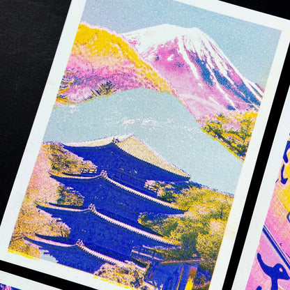 Colorful risograph art print of a Japanese landscape by PTRVRKD featuring Mount Fuji in soft pink and purple tones, a blue traditional pagoda, and vibrant yellow-orange trees. Modern Japanese collage illustration, handprinted with soy inks on high-quality Biotop paper. Perfect for Japan lovers and contemporary design enthusiasts.
