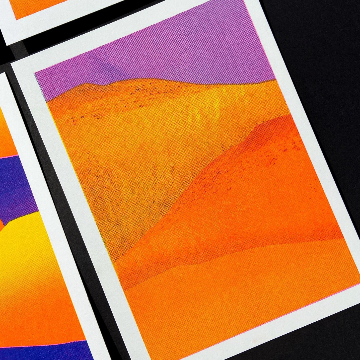 Vibrant yellow and orange sand dunes with bold purple sky, minimalist 13x18 cm risograph landscape print by PTRVRKD, handmade in the Netherlands.