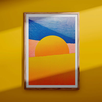Minimalist desert art print with bold yellow sun and African dune landscape in vivid blue, orange, and peach tones by Dutch artist PTRVRKD – A3 risograph print, limited edition, eco-friendly ink.
