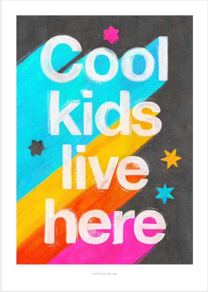 Giclée art print by Just Cool Design with the phrase "Cool kids live here" in bold white letters over a bright rainbow background with stars, ideal for colorful children's rooms or playful modern decor.