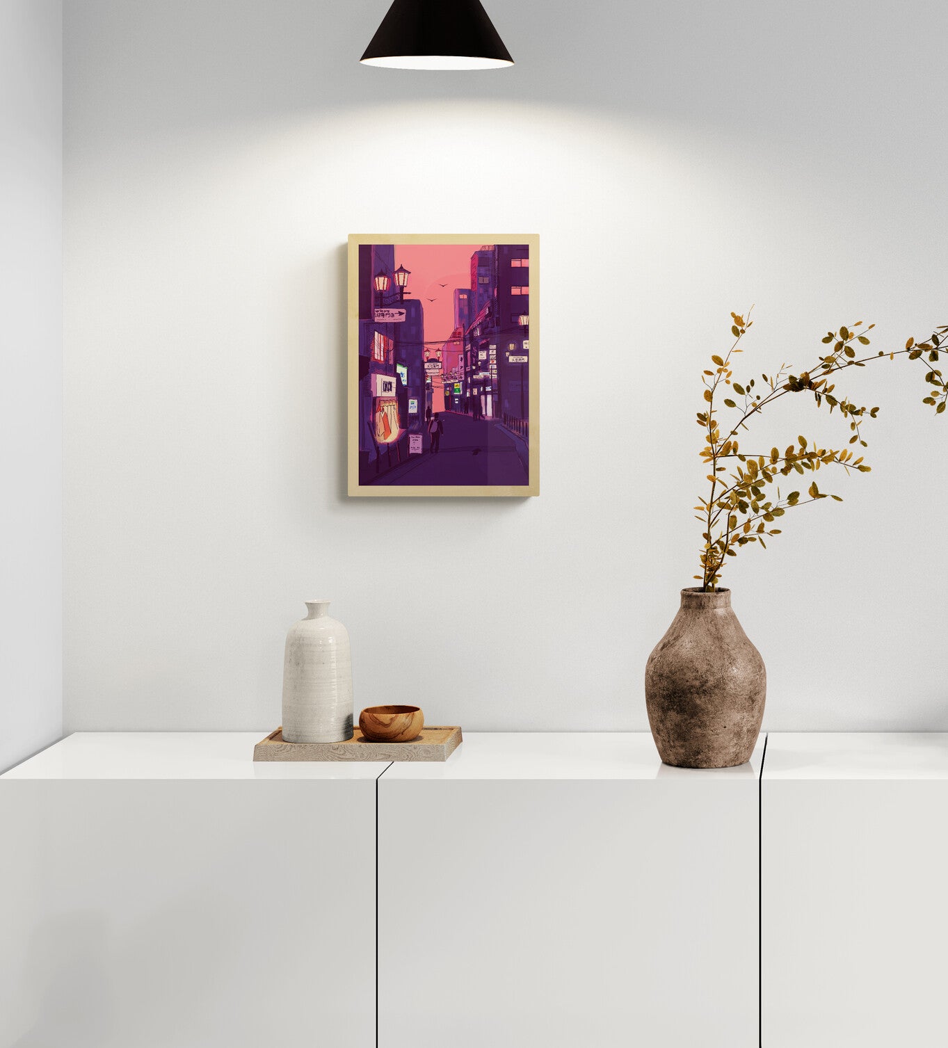 Fine art giclée print titled “Nights in Japan” by Valeria Maggiani featuring a cinematic Japanese city street at dusk with neon signs, warm shop lights, urban silhouettes, and a pink-purple evening sky, printed on 100% cotton textured paper A4 size, ideal for modern home decor and contemporary wall art in Belgium and Europe.