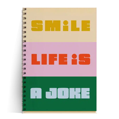 Colorful A5 spiral notebook with bold text "Smile, Life is a Joke" on recycled paper cover, featuring 60 blank pages of 80gsm paper, made in France – perfect for artists, students, and stationery lovers with attitude