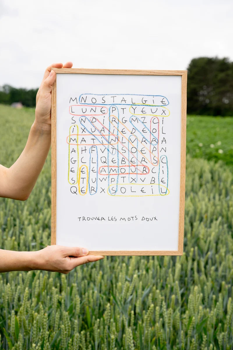 Risograph art print “Les mots doux” by Paul Lecat – colorful word search illustration featuring French words like “amour,” “soleil,” and “nostalgie” drawn in soft red, blue, and yellow lines on white background, poetic modern wall art in A3 format.