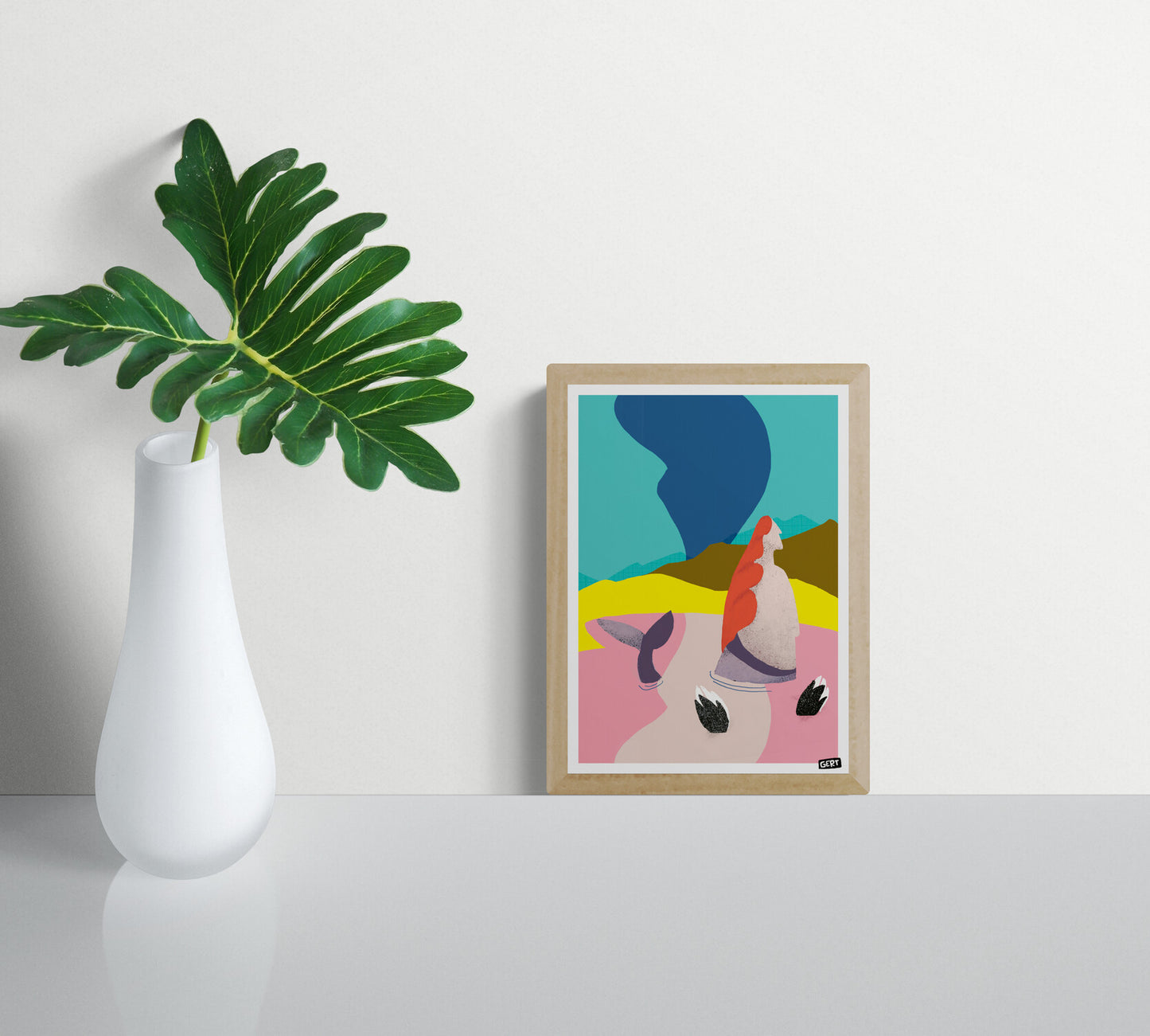 Mermaids 2 by Gert Paenen, colourful contemporary digital art print featuring a stylised mermaid with flowing red hair in a surreal coastal landscape with bright pink water, yellow dunes, blue sky, and modern abstract graphic shapes, printed on premium 300 g/m² paper.