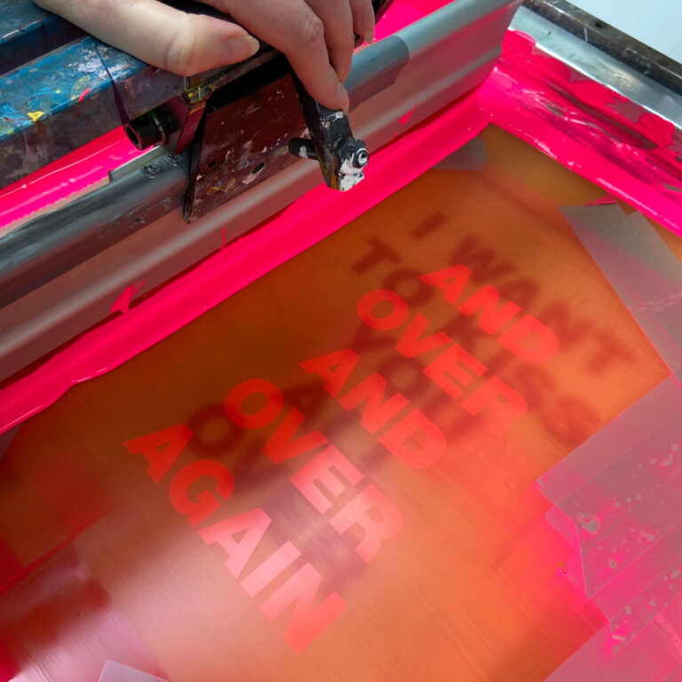 Typography art print ‘I Want to Kiss You All Over’ by Gumbootz, 30×40 cm hand-pulled screen print in bold red and fluorescent pink, modern graphic poster with overlapping text design, contemporary wall art for lovers of expressive, romantic prints.