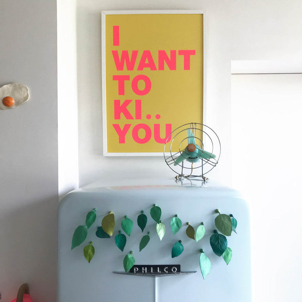 Large handmade screenprint with bold pink and yellow text reading "I want to ki.. you" — playful, humorous poster by Dutch studio Gumbootz, ideal for modern interiors and statement walls.